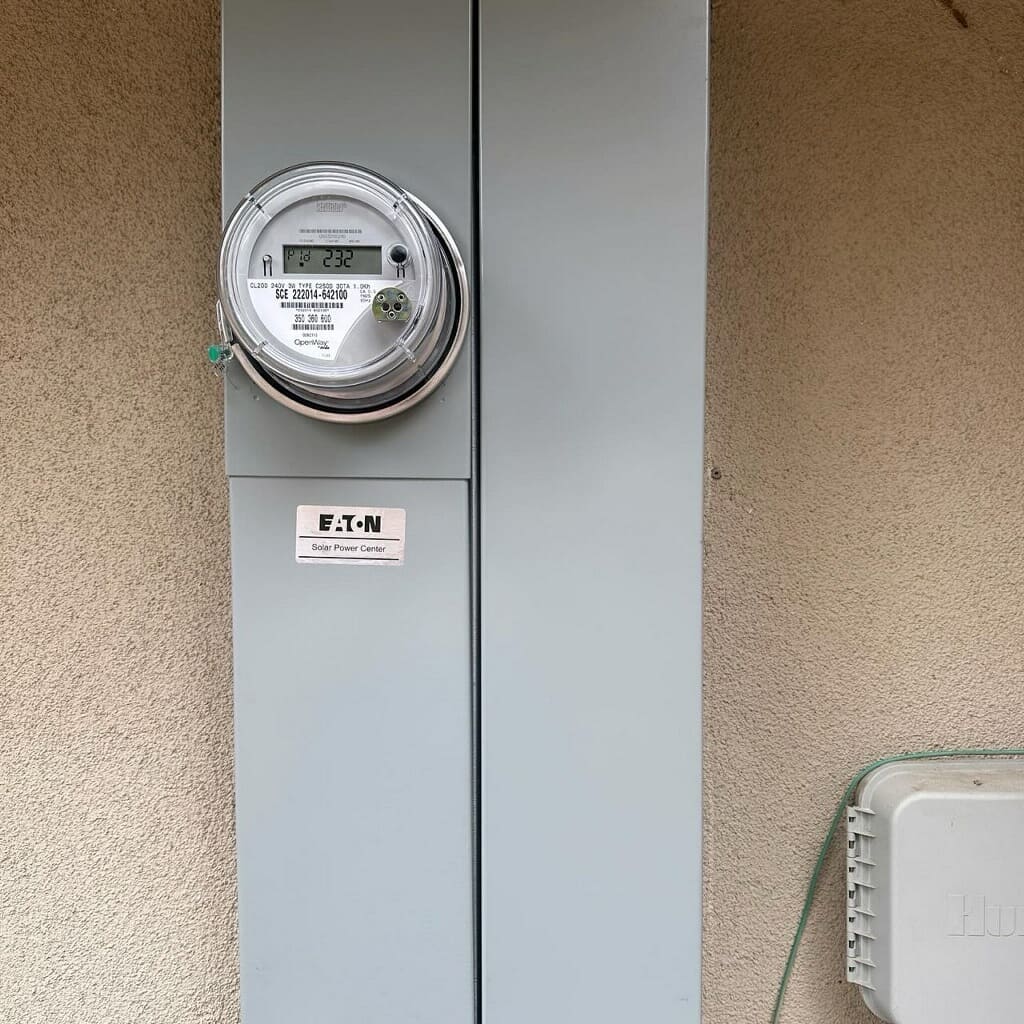Eaton solar power center with electric meter installed on residential exterior wall